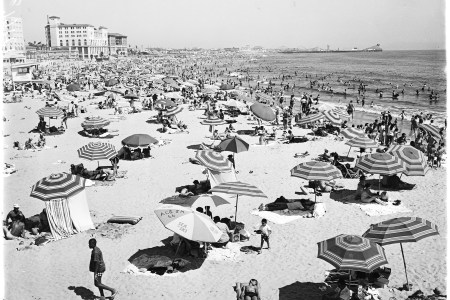 General views of crowd at Santa Monica beach, Santa Monica, California, April 13, 1958. Nick Gabaldón Day now celebrates the contributions of black surfers in California to combatting racism on the beaches. (Photo by USC Libraries/Corbis via Getty Images)