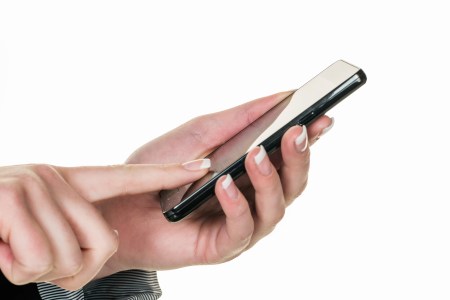 An iPhone in an user's hand. Apple recently took out a patent for a technology that would better detect and prevent spam calls. (Photo by Wodicka/ullstein bild via Getty Images)