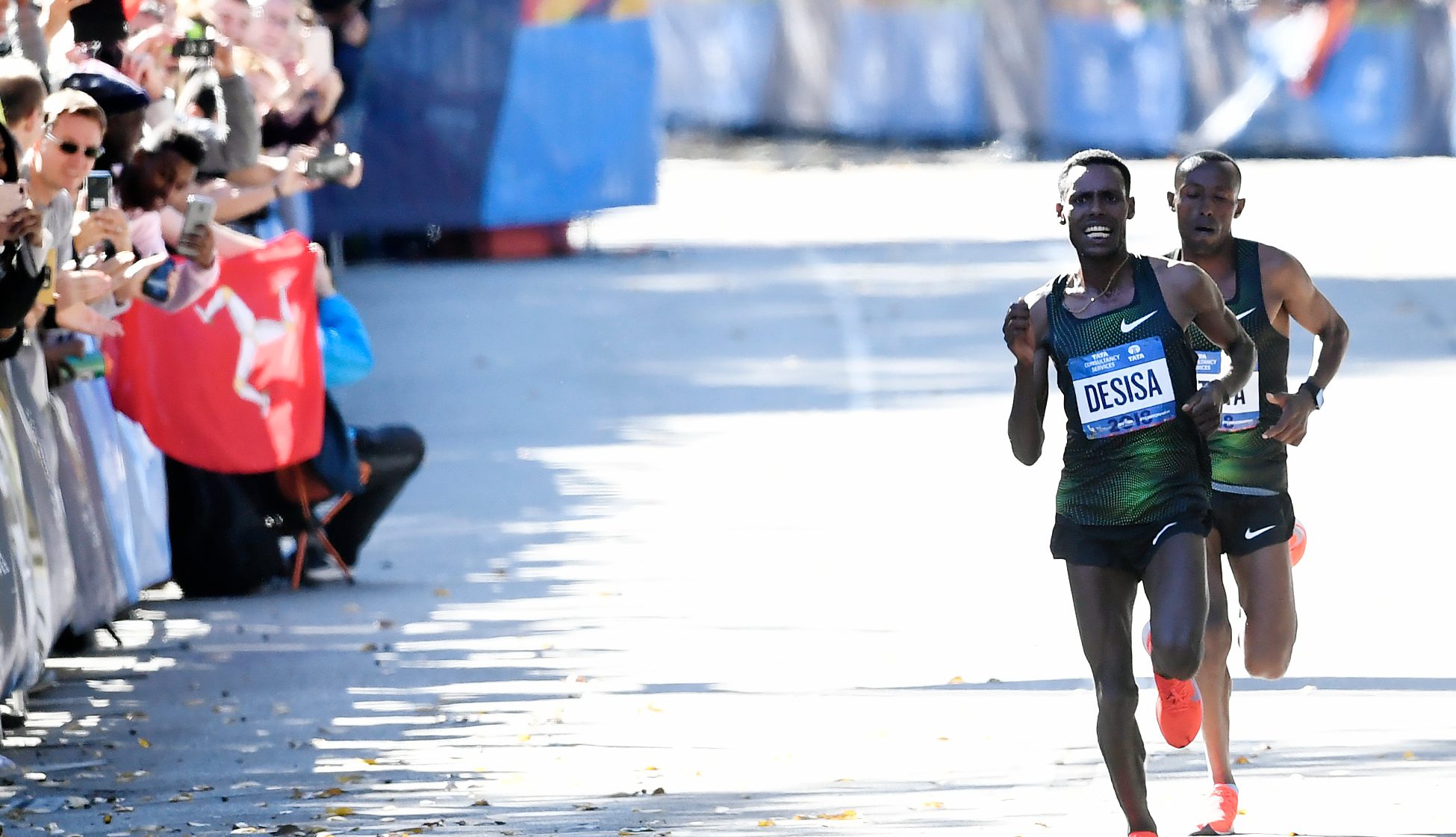 In the final stretch of the 2018 New York City Marathon, Ethiopia's Lelisa Desisa sprints ahead of Sharu Kitata on the way to winning the race by two seconds, with a time of 2:05.59. (Photo by Sarah Stier/Getty Images)