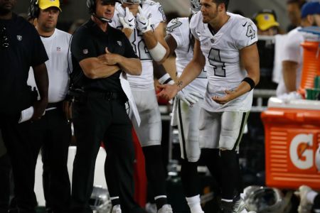 Oakland Raiders starting quarterback Derek Carr #4 talks to Oakland Raiders head coach Jon Gruden on the sidelines after Carr was pulled from the game against the San Francisco 49ers in the fourth quarter at Levi's Stadium on Thursday, Nov. 1, 2018 in Santa Clara, California.  (Nhat V. Meyer/Digital First Media/The Mercury News via Getty Images)