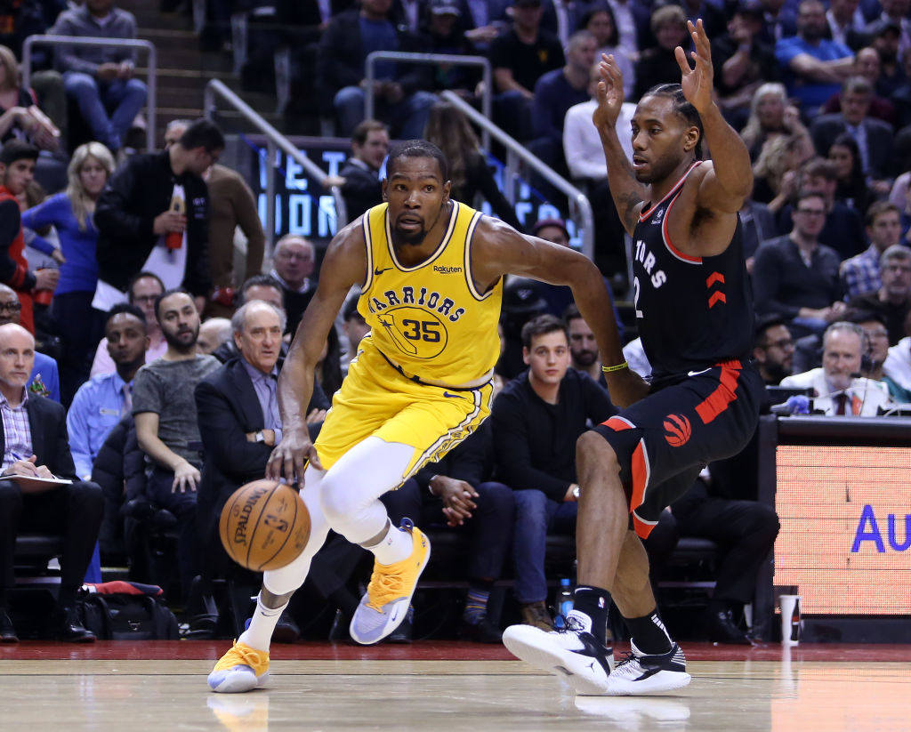 TORONTO, ON - NOVEMBER 29:  Kevin Durant #35 of the Golden State Warriors dribbles the ball as Kawhi Leonard #2 of the Toronto Raptors defends during the second half of an NBA game at Scotiabank Arena on November 29, 2018 in Toronto, Canada. (Photo by Vaughn Ridley/Getty Images)