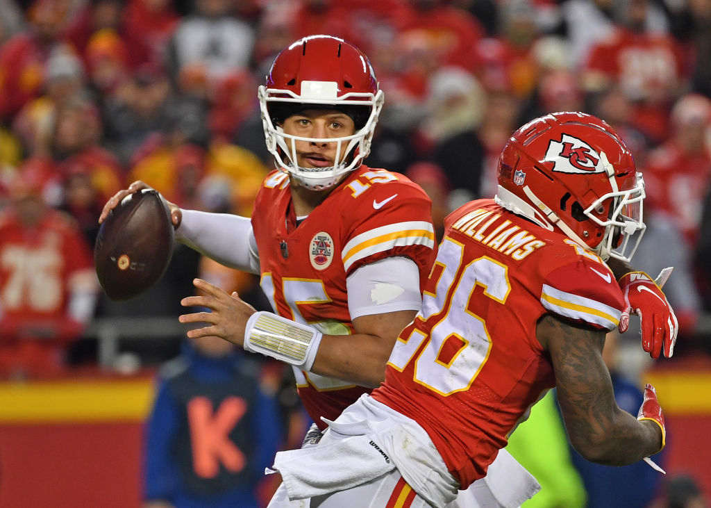 KANSAS CITY, MO - DECEMBER 30: Quarterback Patrick Mahomes #15 of the Kansas City Chiefs looks to throw a pass to the outside, after faking a handoff to running back Damien Williams #26 against the Oakland Raiders during the second half at Arrowhead Stadium on December 30, 2018 in Kansas City, Missouri. (Photo by Peter G. Aiken/Getty Images)