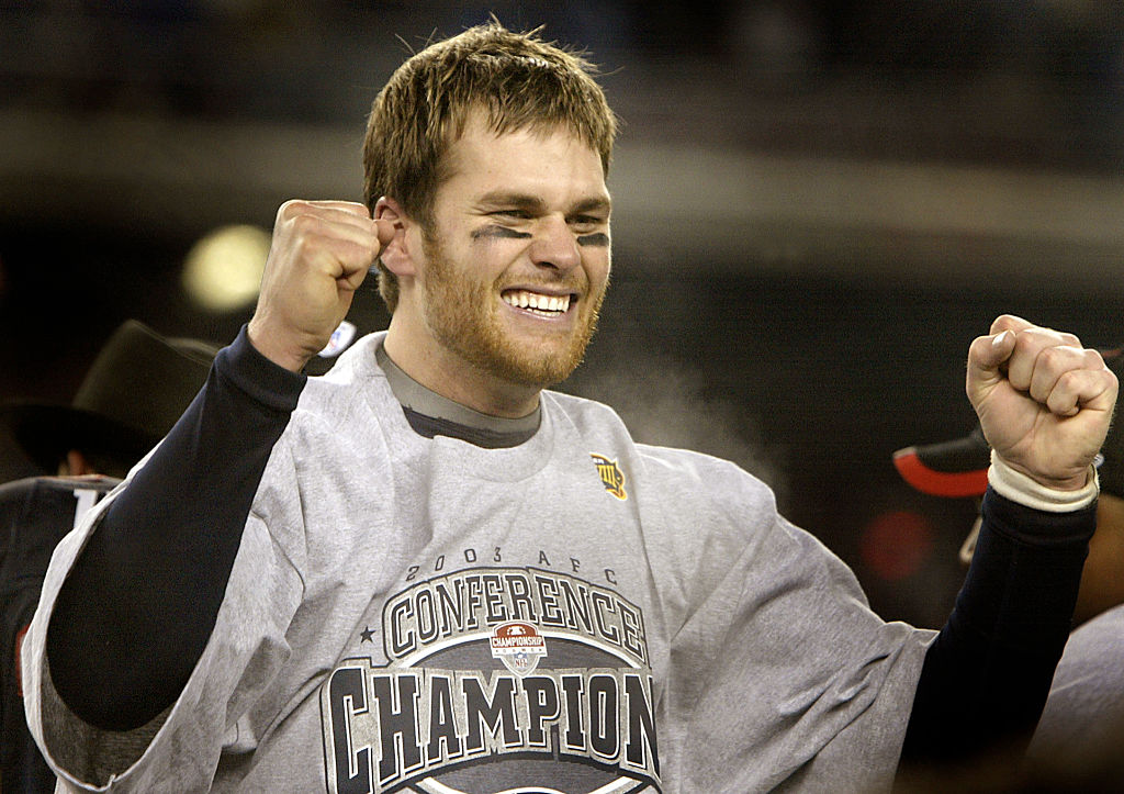 An exuberant Tom Brady on the AFC Championship podium following the New England Patriots' win over the Indianapolis Colts to advance to the Superbowl in Houston, TX. (Photo by Barry Chin/The Boston Globe via Getty Images)