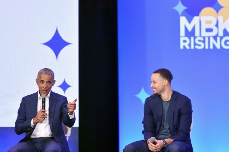 Former President Barack Obama (L) speaks alongside Golden State Warriors basketball player Stephen Curry (R) during the MBK Rising! My Brother's Keeper Alliance Summit in Oakland, California on February 19, 2019. (Photo by Josh Edelson / AFP)        (Photo credit should read JOSH EDELSON/AFP/Getty Images)