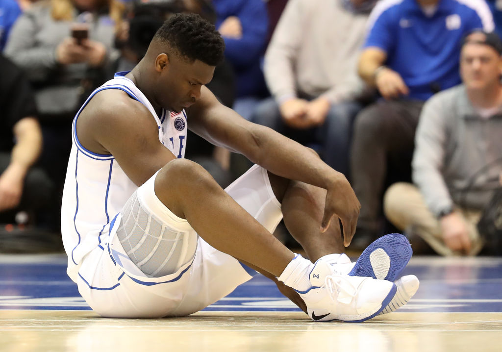 DURHAM, NORTH CAROLINA - FEBRUARY 20: Zion Williamson #1 of the Duke Blue Devils reacts after falling as his shoe breaks against Luke Maye #32 of the North Carolina Tar Heels during their game at Cameron Indoor Stadium on February 20, 2019 in Durham, North Carolina. (Photo by Streeter Lecka/Getty Images)