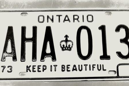 CANADA - FEBRUARY 21: Playing the numbers game is no joke; A penitentiary inmate somewhere played a game while making license plates and at Sudbury; Pauline Robinson found this CO-KANE plate among the others. It will be returned to the Ministry of Communications and Transportation. The ministry complains that 37 per cent of Ontario owners still haven't got their new plates. One who did today found he'd got plates exclaiming aha at unlucky 13. (Photo by Jeff Goode/Toronto Star via Getty Images)