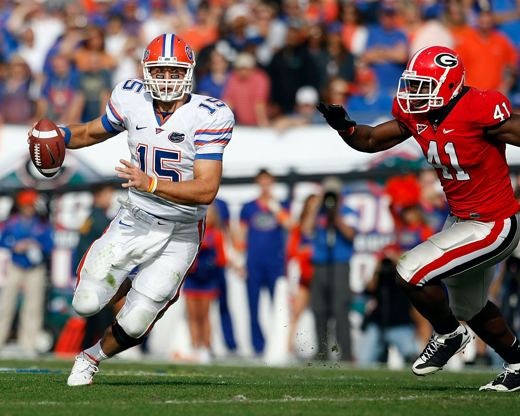 Florida quarterback Tim Tebow (15) scrambles as he is flushed from the pocket by Georgia defensive end Roderick Battle (41) in the Florida Gators 49-10 victory over the Georgia Bulldogs at Jacksonville Municipal Stadium in Jacksonville, FL. (Photo by Todd Kirkland /Icon SMI/Icon Sport Media via Getty Images)