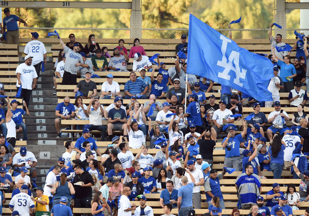 LOS ANGELES, CA - OCTOBER 07: A fan in the left field pavilion runs through the crowd with an LA flag during game 2 of the NLDS between the Arizona Diamondbacks and the Los Angeles Dodgers on October 07, 2017 at Dodger Stadium in Los Angeles, CA. (Photo by Chris Williams/Icon Sportswire via Getty Images)