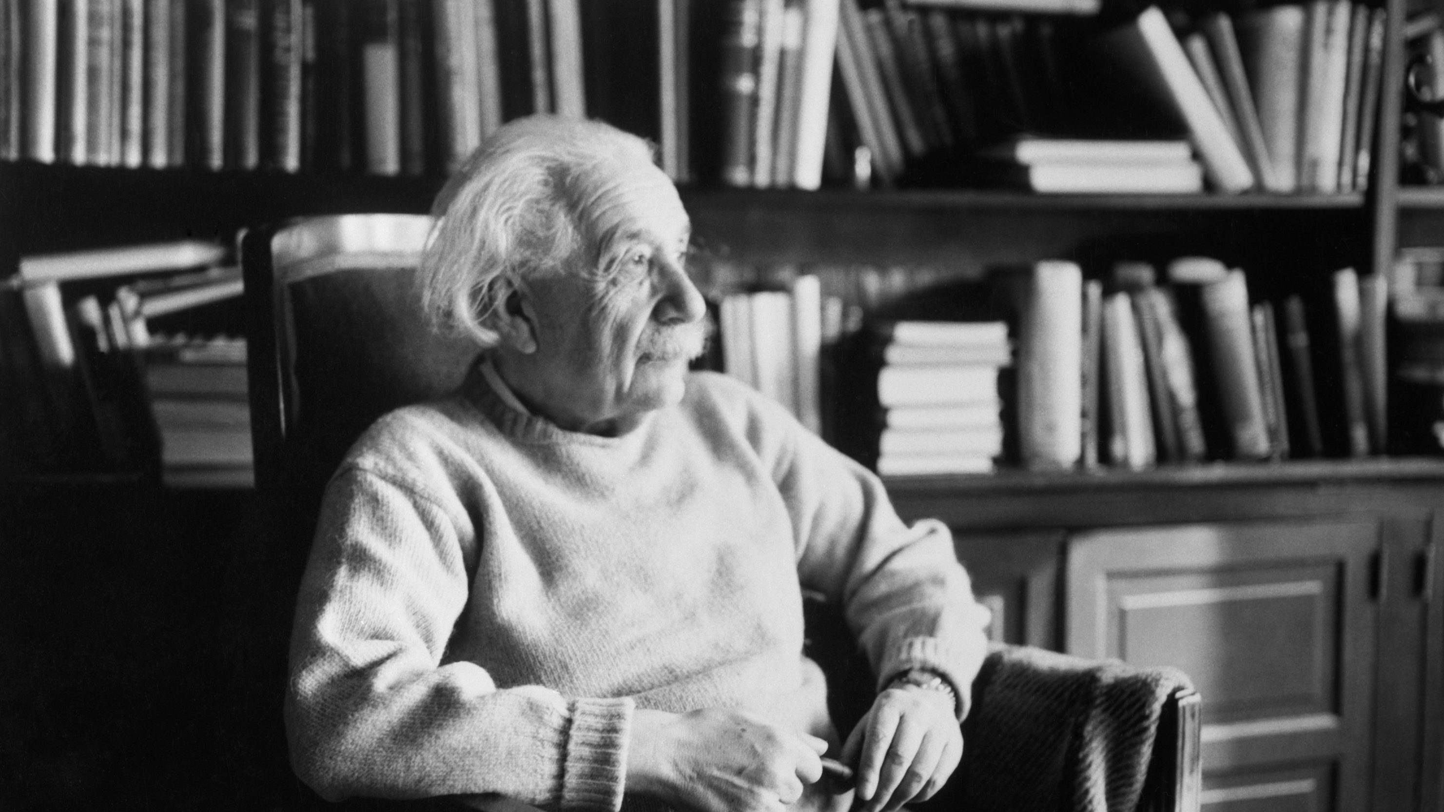 Princeton, New Jersey: Physicist Albert Einstein (1879-1955), seated in book-filled office. (Getty Images)