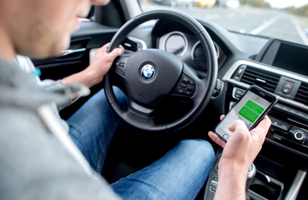 A young man is sitting at a driving safety center. (Photo by Hauke-Christian Dittrich/picture alliance via Getty Images)