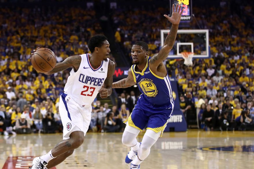 Lou Williams drives on Alfonzo McKinnie. (Ezra Shaw/Getty)