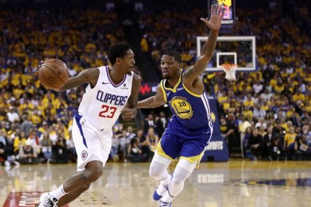 Lou Williams drives on Alfonzo McKinnie. (Ezra Shaw/Getty)