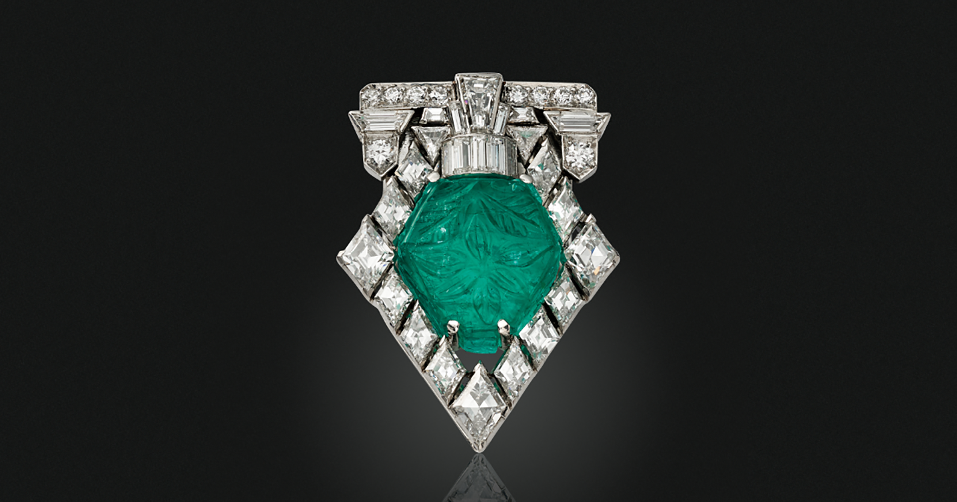 A Tiffany Art Deco carved emerald and diamond brooch