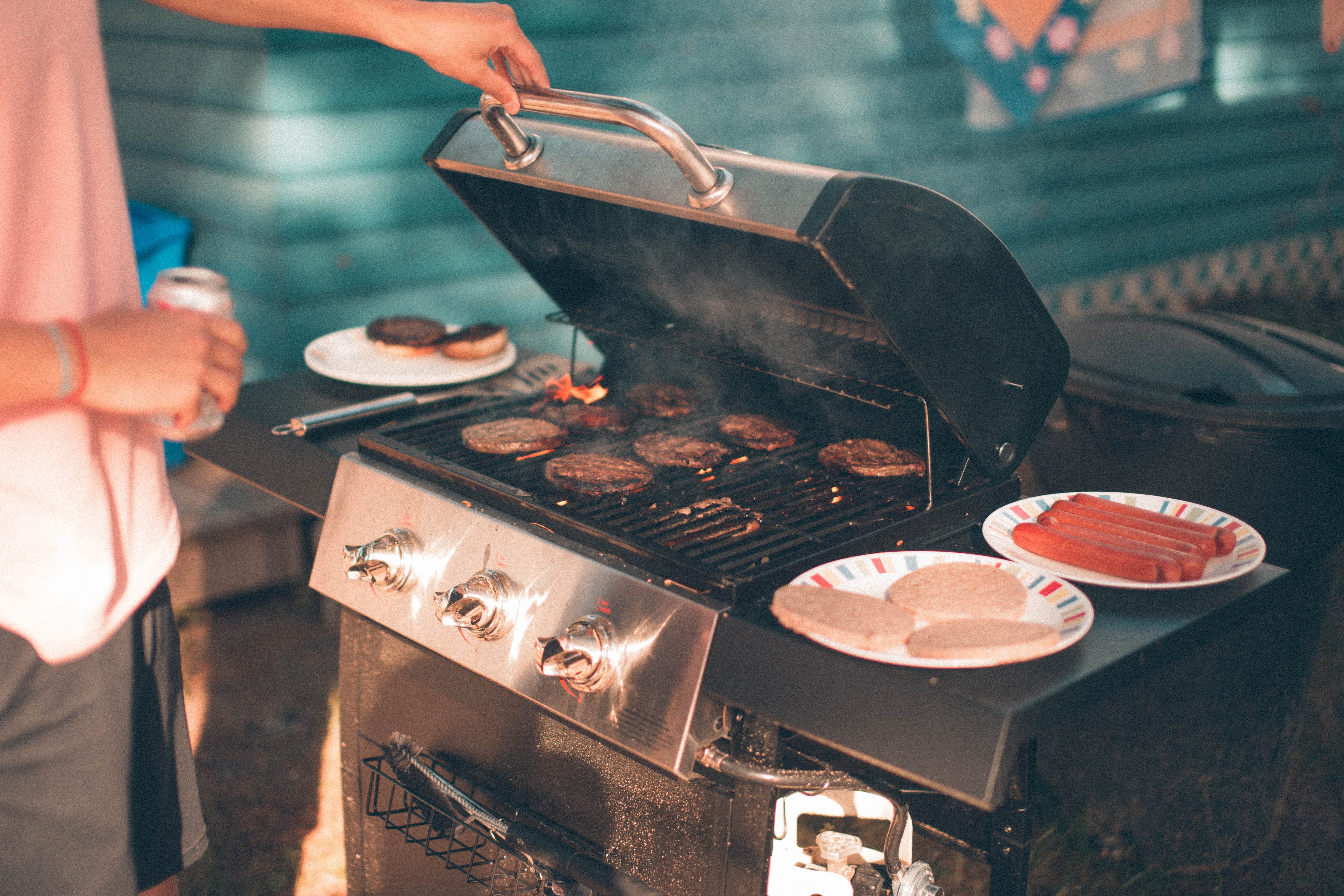 A presumably male griller checking to make sure he seared in the juices
