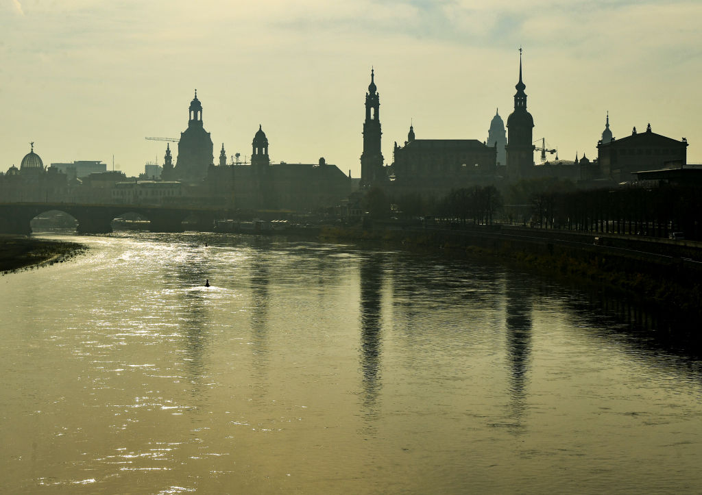 Saxony, Dresden: The silhouette of the old town is reflected in the morning in foggy weather in the Elbe.  (Photo by Jens Kalaene/picture alliance via Getty Images)