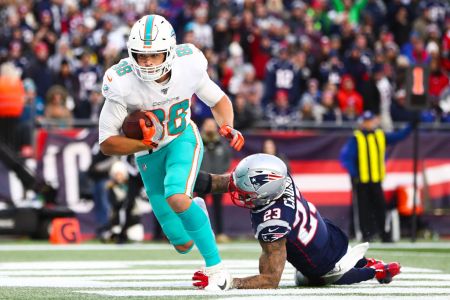 Mike Gesicki of the Miami Dolphins scores a touchdown in the fourth quarter during a game against the New England Patriots at Gillette Stadium on December 29, 2019 in Foxborough, Massachusetts.  (Photo by Adam Glanzman/Getty Images)