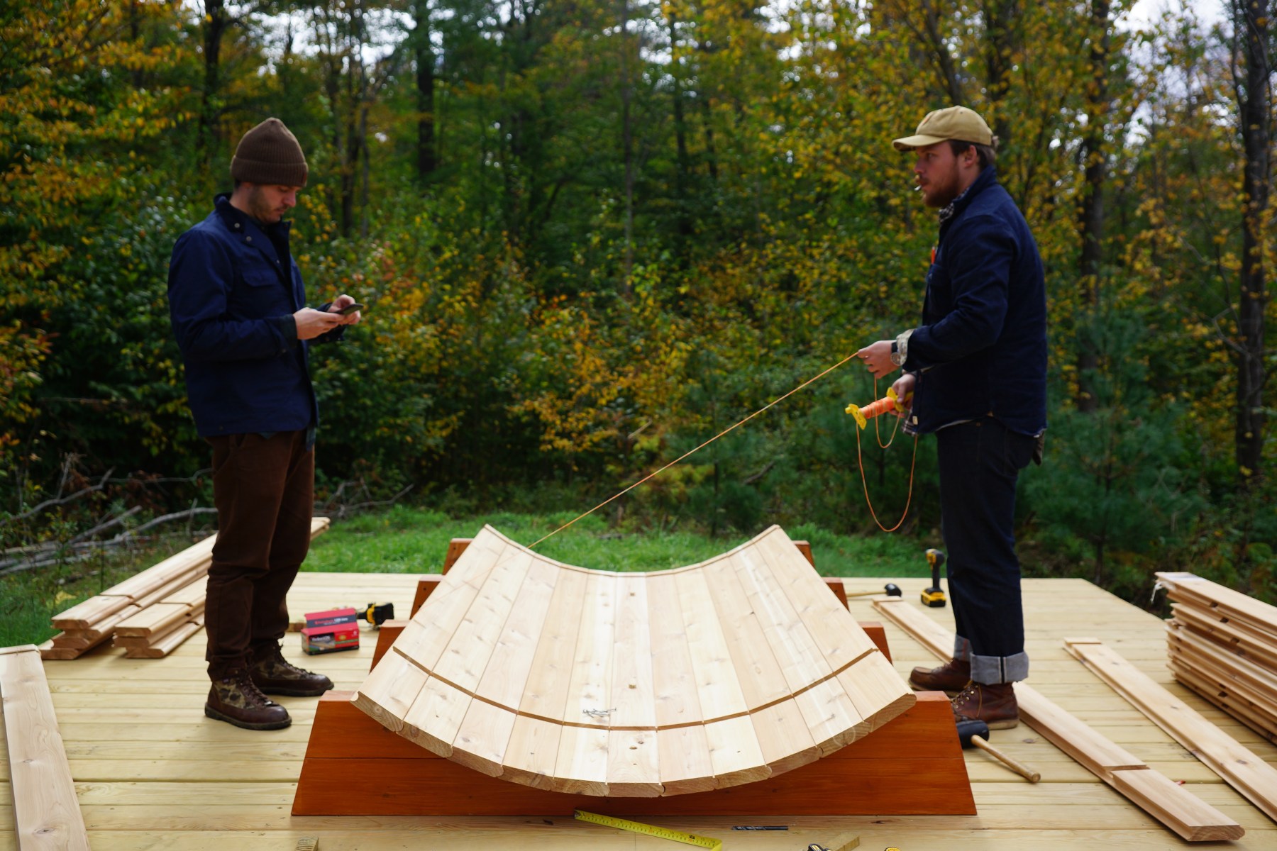 <strong>Building the Barrel with Staves</strong><br>“It's the same essential premise as building a whiskey barrel. You take the staves, which are generally notched or tongue-and-grooved, then stack them in a sequential path and tape them together. Once you get halfway up, you bring the sides and ends in to hold them in place. You have to creep the boards up, because they aren't held in — it's just pressure, they're gravitationally held. You use tape to hold them together. With the last couple staves, try to jam in as many as you possibly can. Then grab the hoops that go around the sides and tighten those with bolts while simultaneously taking a rubber mallet and banging and hammering the hoop itself around the entire barrel. It's a two-man job. You hammer one set, tighten it, go to the next one, hammer it, tighten it and keep going back and forth until it's super tight. Once it rains and that wood gets wet, it'll expand and become waterproof.”<br>