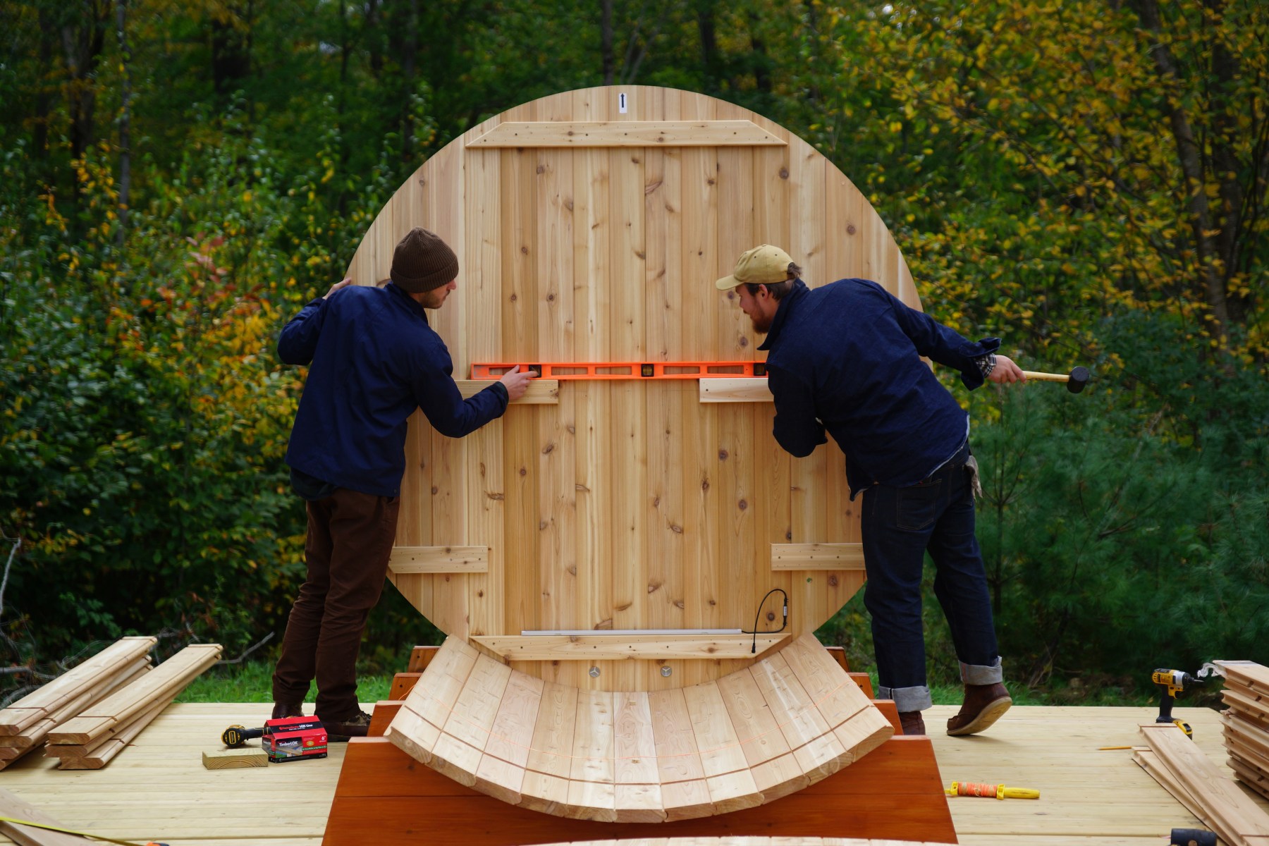 <strong>Installing the Ends</strong><br>“The ends are grooved circular pieces that are married together with furniture pegs — dowels, essentially. In this instance, there was a door that was already prebuilt. Either way, you use the ends to hold those staves in place. You can put staves across the bottom supports because those are rounded. But once you hit the edge of that, there's nothing for them to hold onto. They'll legitimately just fall, so at that point you have to bring in the ends. We ran strings to tie the ends together as we placed in the staves to carry up the rest of the sidewalls.”