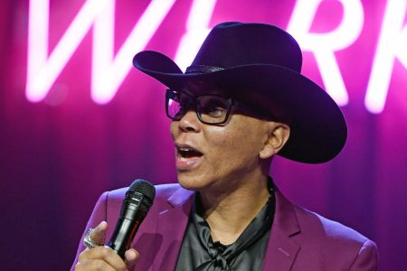 Drag queen RuPaul holding a microphone