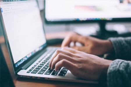 Person typing on a laptop computer
