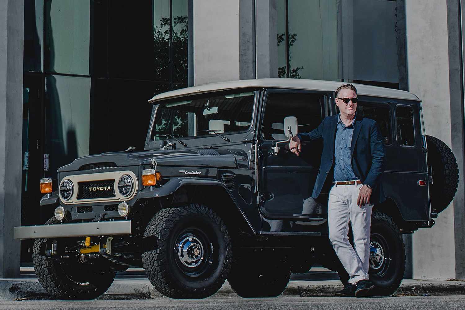 Menswear designer Todd Snyder next to an SUV