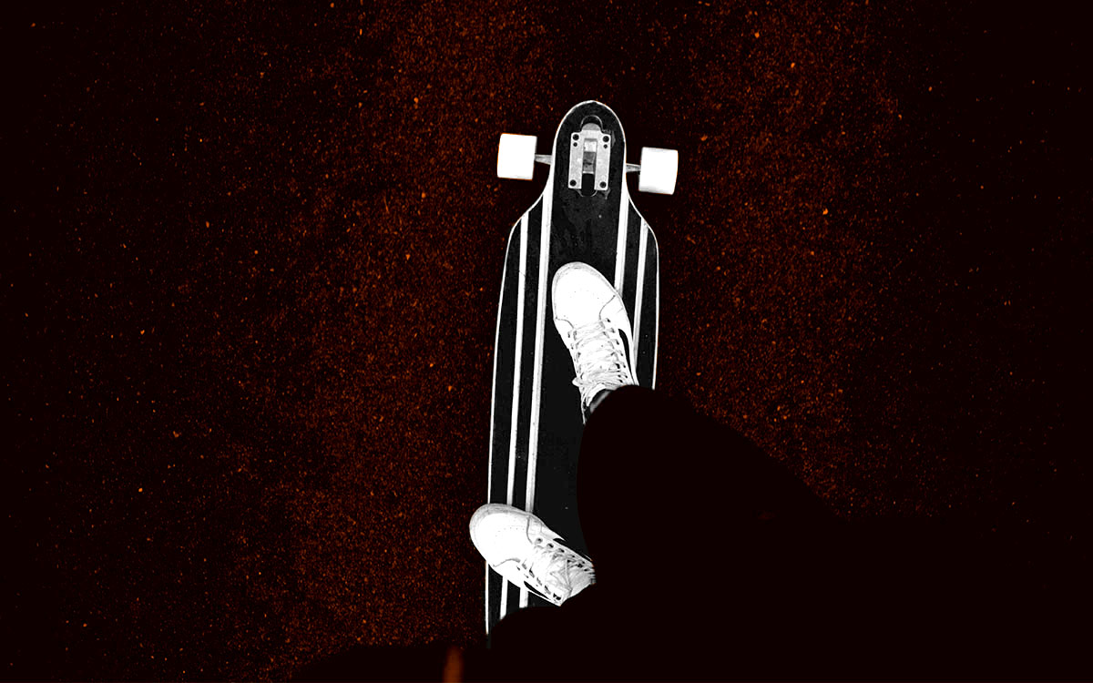 Three longboarders riding down a scenic hill on a sunny day, with motion blur emphasizing speed.