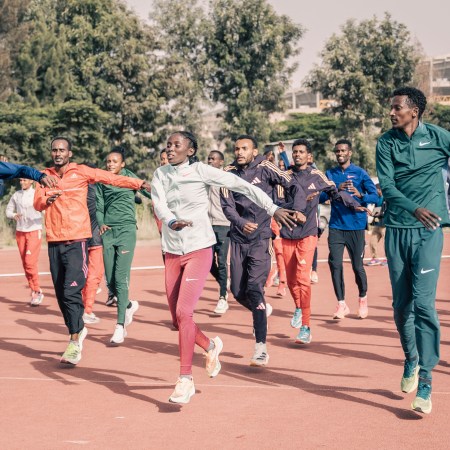 A group of Olympic runners warming up before a run.