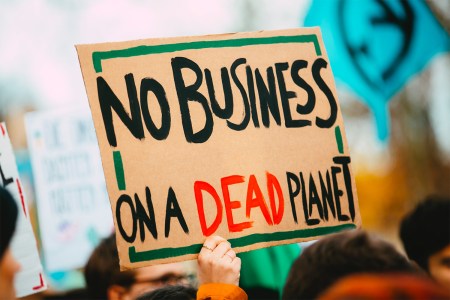 Holding up a protest sign at a climate change rally
