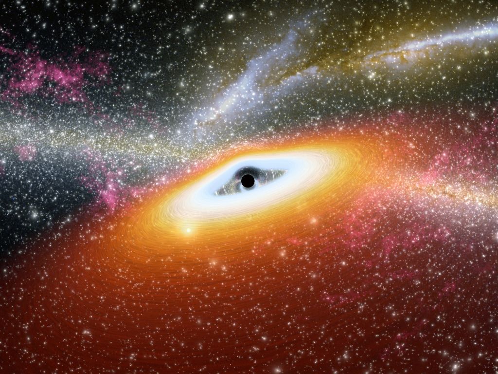 This artist's conception illustrates one of the most primitive supermassive black holes known (central black dot) at the core of a young, star-rich galaxy. (Photo by: Photo12/Universal Images Group via Getty Images)
