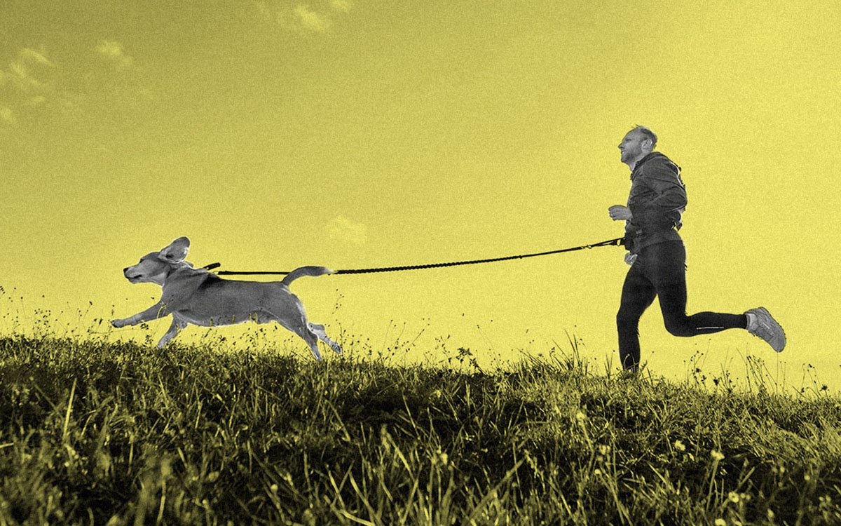 man running with dog