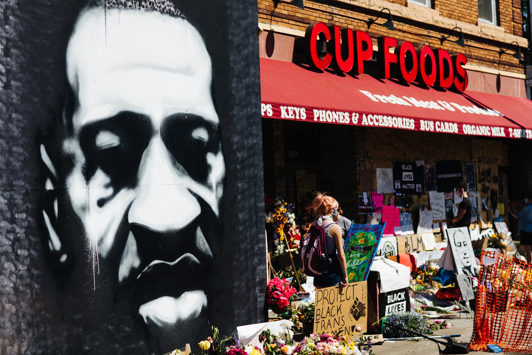 Last week, gatherers helped hoist up this monumental black-and-white portrait of George Floyd.