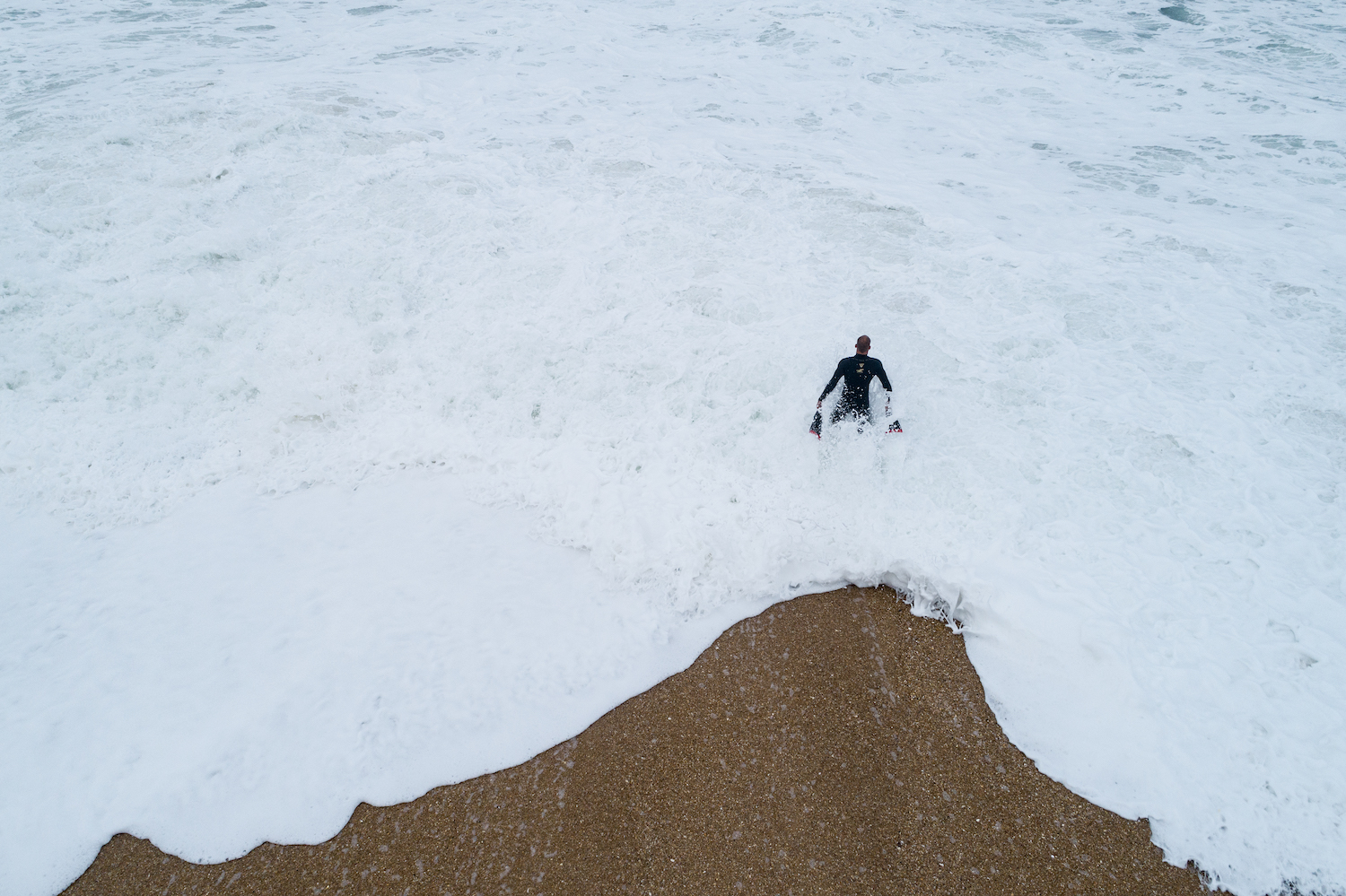 Kalani Lattanzi stands in the ocean