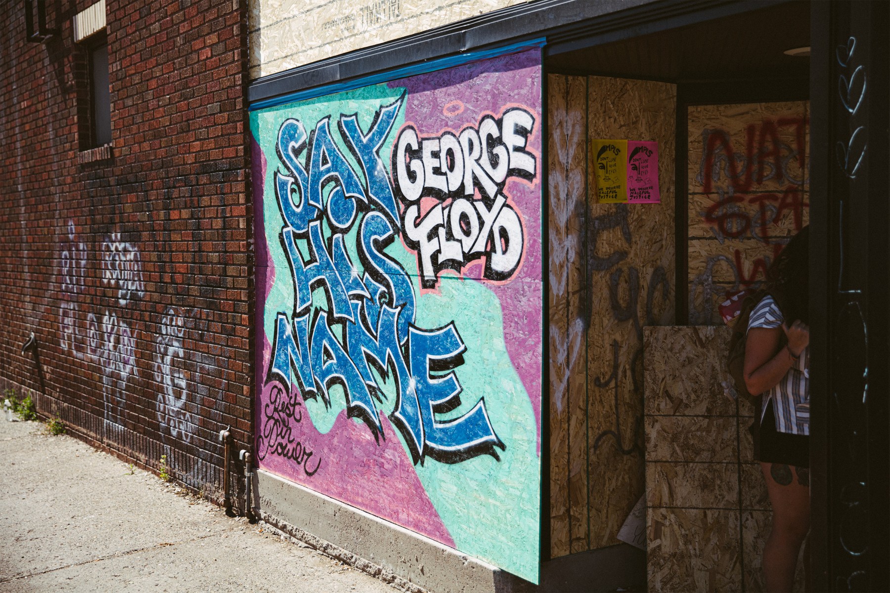 The plywood that covers many businesses throughout the Twin Cities is being repurposed as canvas.