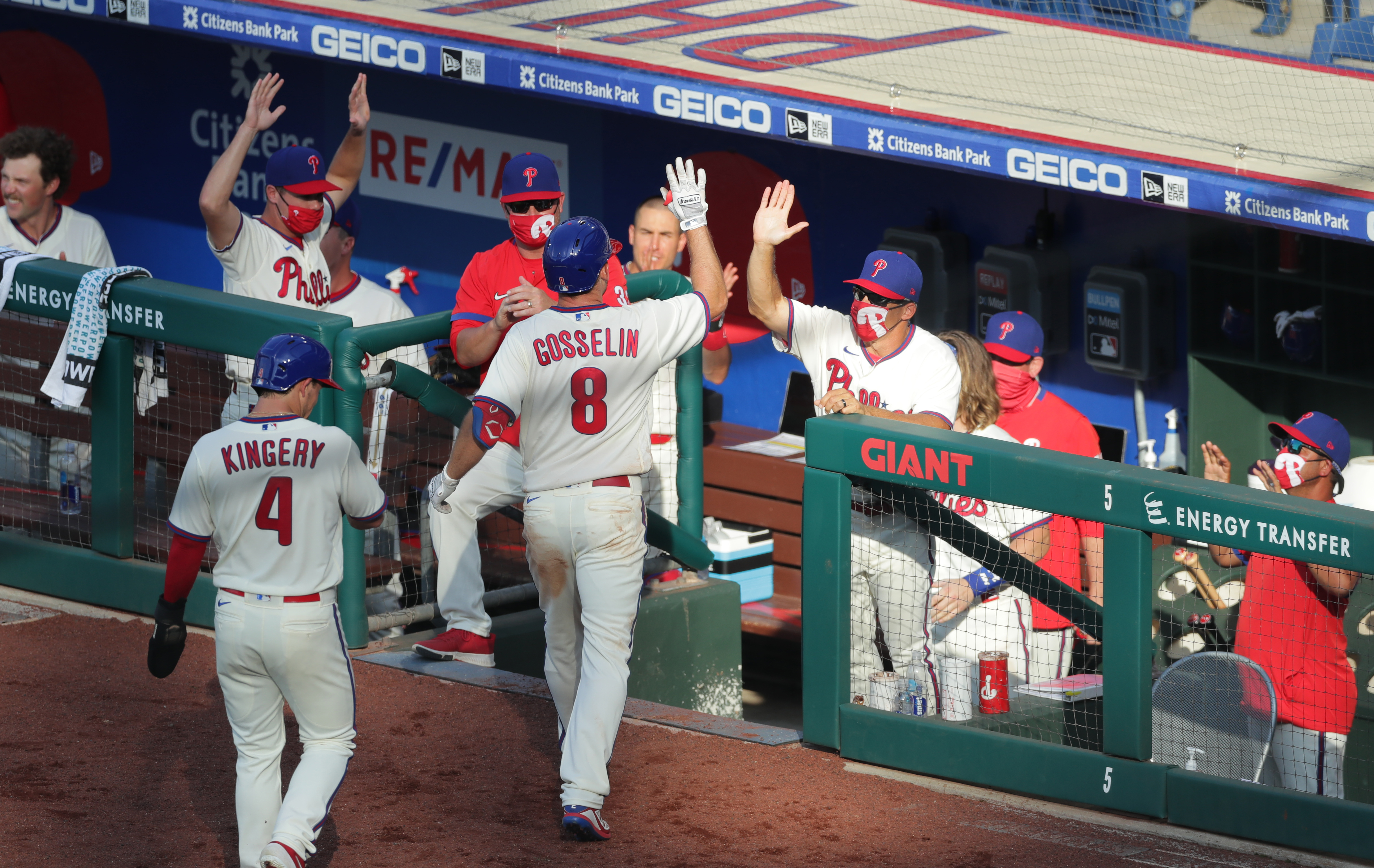 Phil Gosselin of the Philadelphia Phillies high fives manager Joe Girardi after hitting a two-run home run in the sixth inning during a game against the Miami Marlins at Citizens Bank Park on July 25, 2020 in Philadelphia, Pennsylvania. The 2020 season had been postponed since March due to the COVID-19 pandemic. (Photo by Hunter Martin/Getty Images)