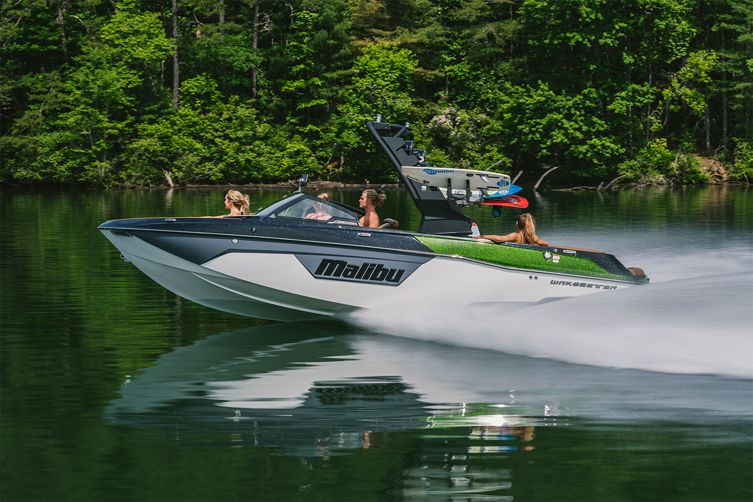 The 2021 Malibu Boats 23 LSV wakesetter towboat speeding across a lake
