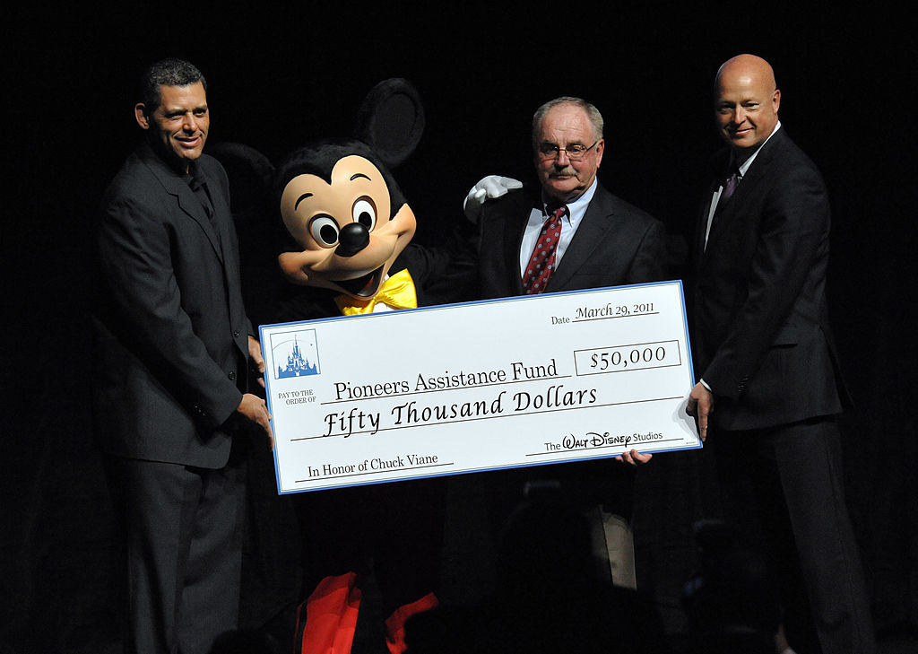 Executive Director of Will Rogers Motion Pictures Pioneers Foundation Todd Vradenburg, Mickey Mouse, Chairman the Will Rogers Motion Picture Pioneers Foundation Chuck Viane, and The Walt Disney Studios president of Distribution Bob Chapek attend the CinemaCon, the official convention of the National Association of Theatre Owners, at The Colosseum of Caesars Palace on March 29, 2011 in Las Vegas, Nevada.