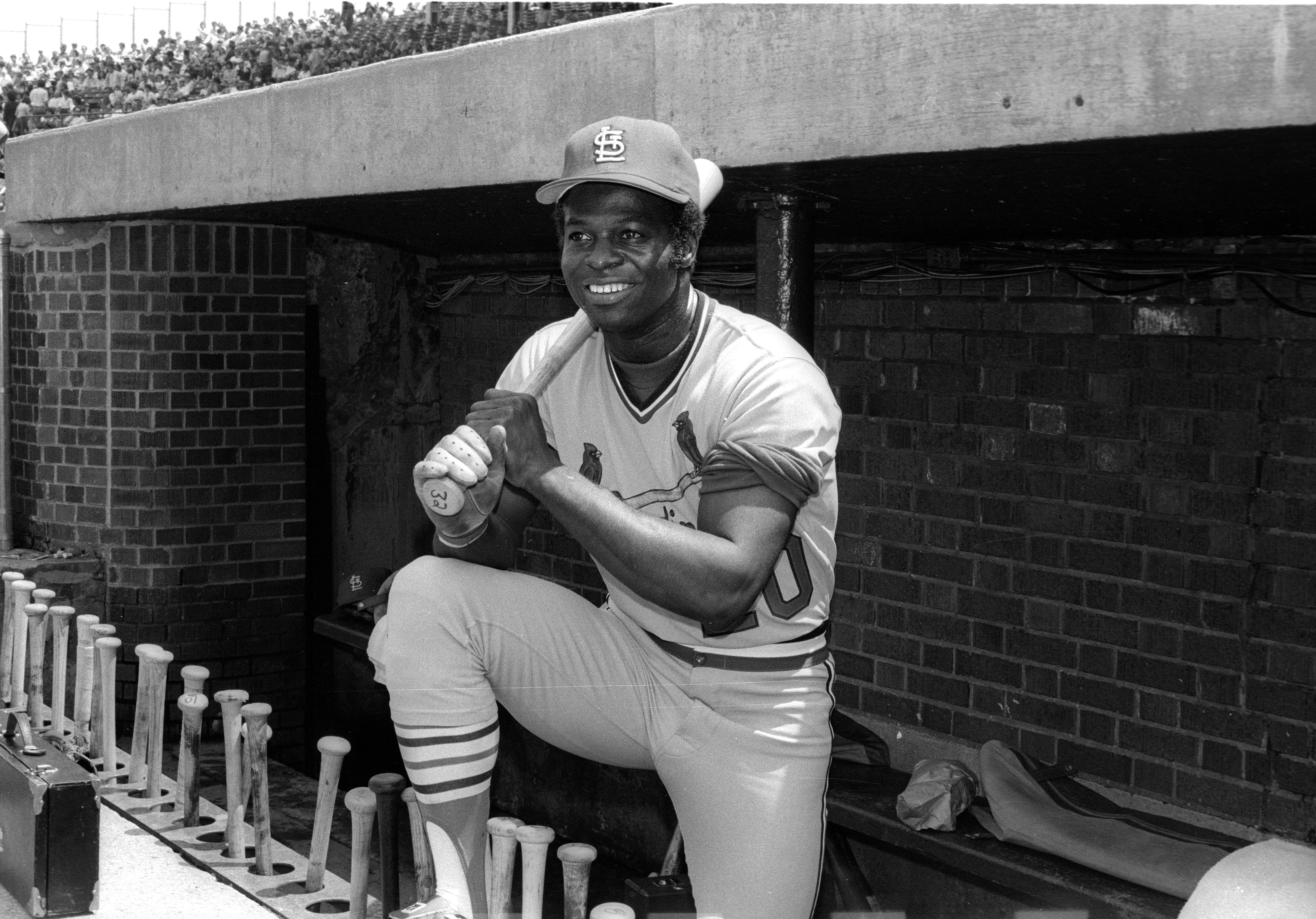 Lou Brock poses in the dugout.