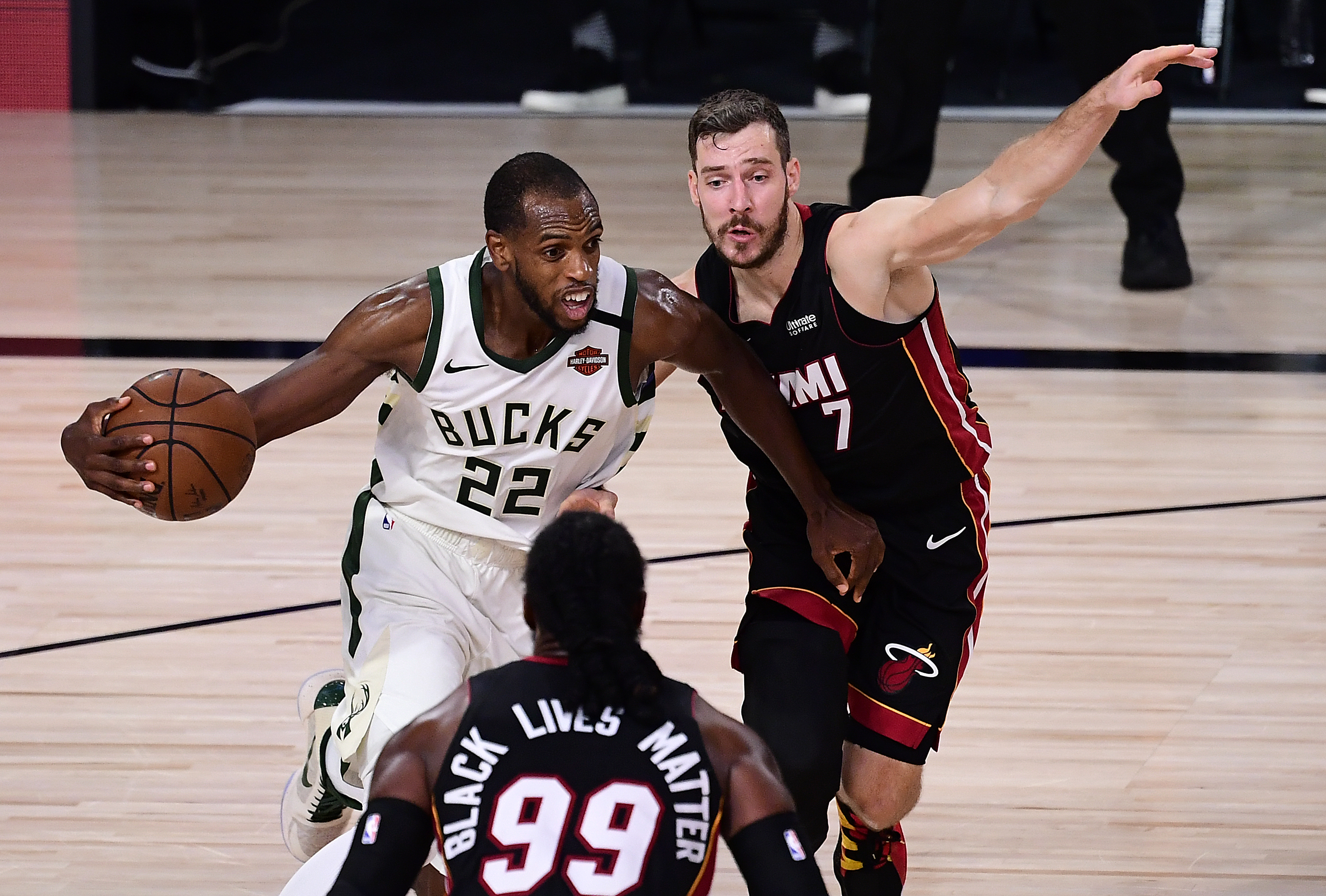 Khris Middleton drives against Goran Dragic