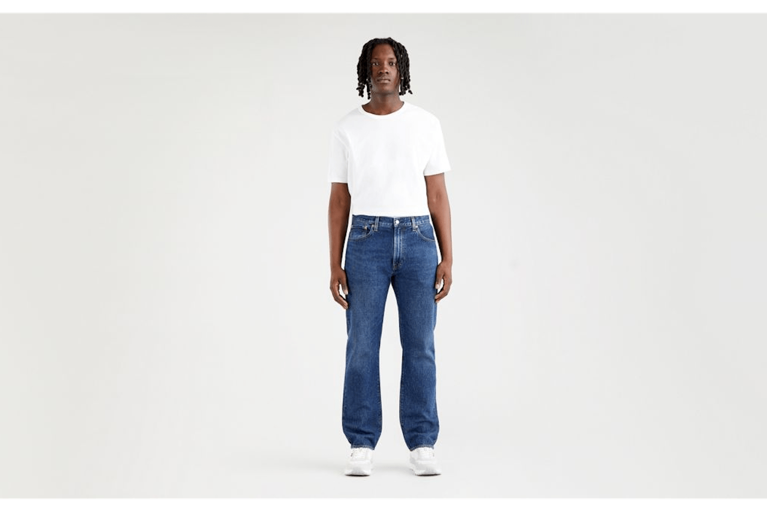 a model in a pair of Levi's jeans on a white background