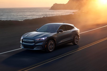 Ford Mustang Mach-E electric crossover SUV driving next to the ocean
