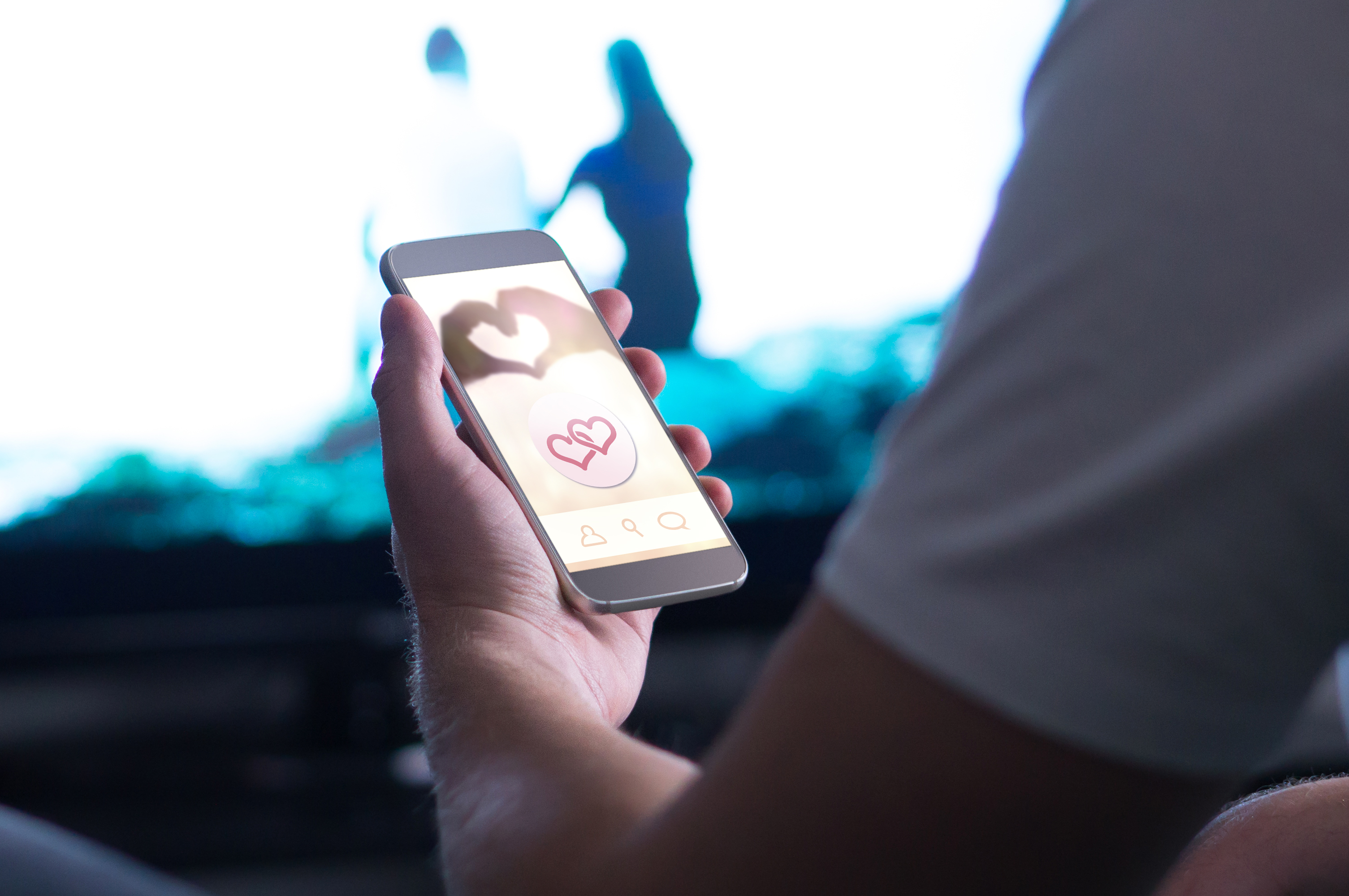 person holding a phone open to a dating apps