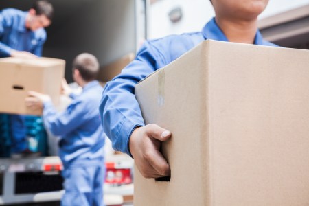 three movers unloading carboard boxes