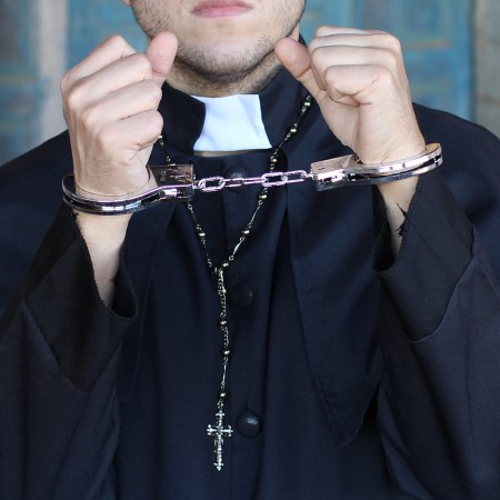 priest wearing handcuffs