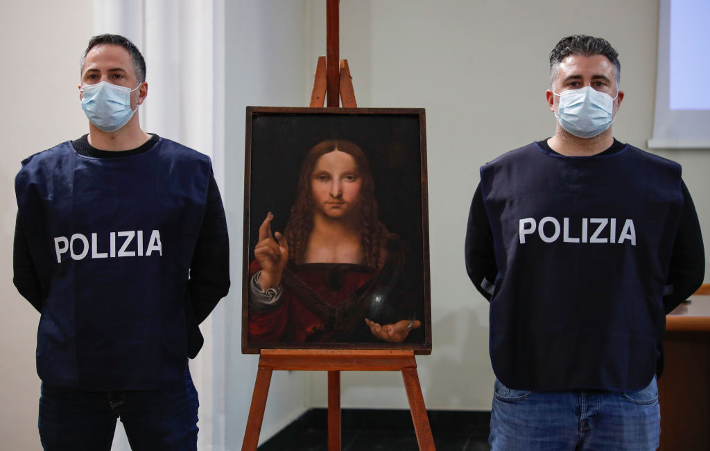 Policeman show the "Salvator Mundi", a painting from the