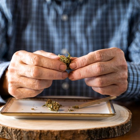 old person rolling a joint