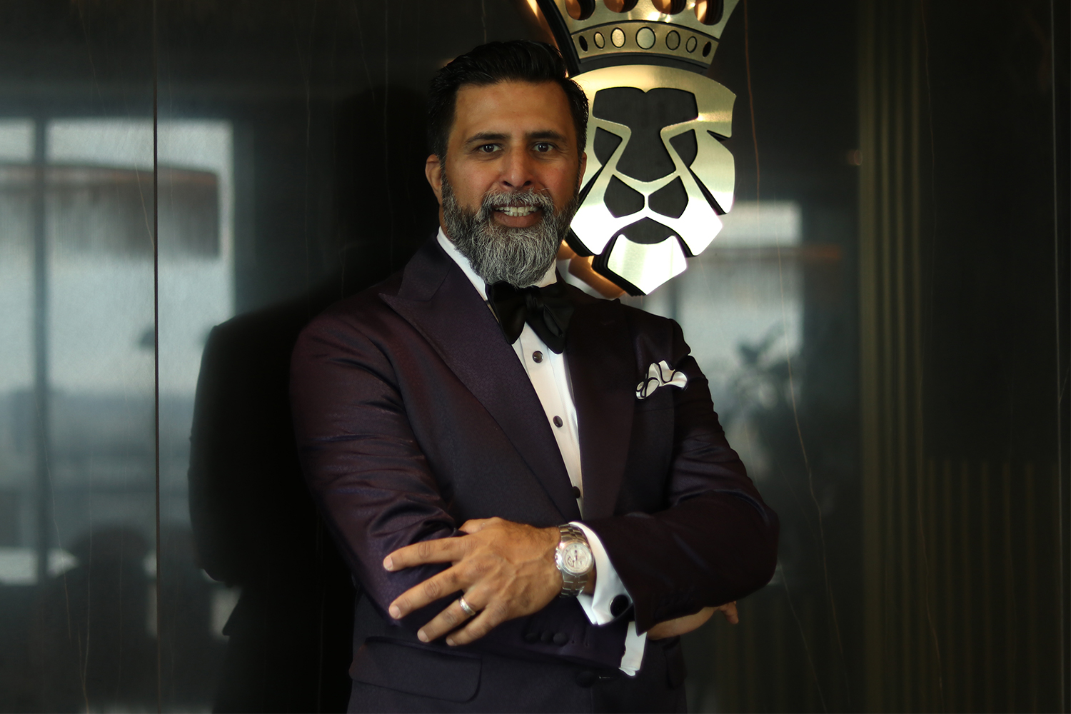 Aashif Jamani posing with his arms crossed at menswear boutique King & Bay