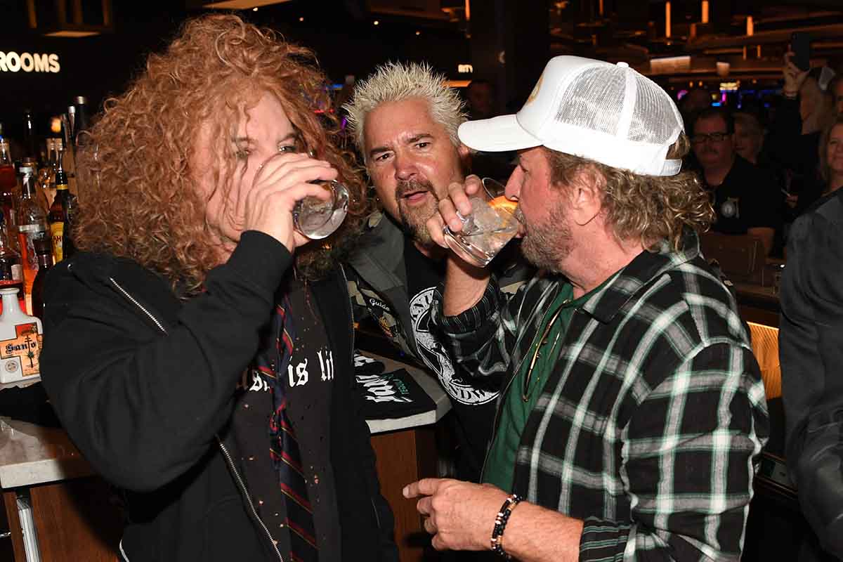 Comedian Carrot Top, restaurateur/tv personality Guy Fieri and musician/entrepreneur Sammy Hagar celebrate the reinvention of The STRAT Hotel, Casino & SkyPod with Santo Blanco Tequila and Sammy's Beach Bar Rum on January 22, 2020 in Las Vegas, Nevada