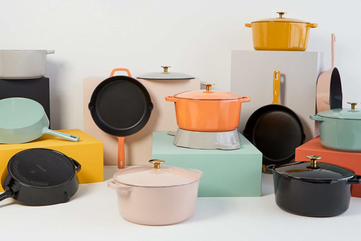 The Milo Dutch oven and skillet, in dijon yellow, sitting on a stove. We tested and reviewed the cookware.