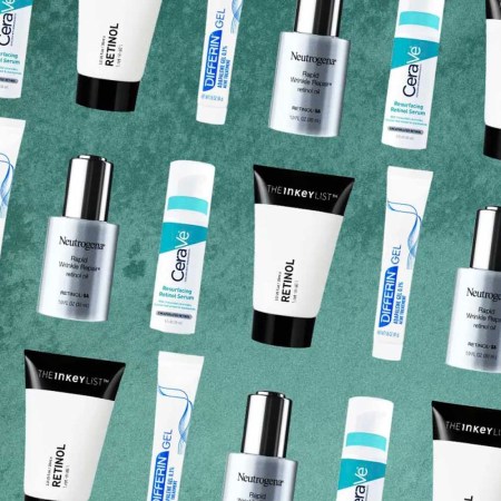 A collection of bottles of topical retinol on a green background.