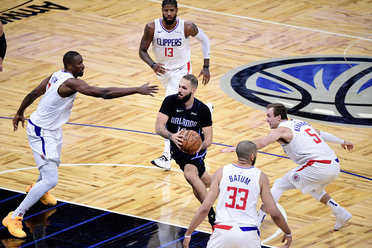 Evan Fournier #10 of the Orlando Magic drives to the net between multiple LA Clippers